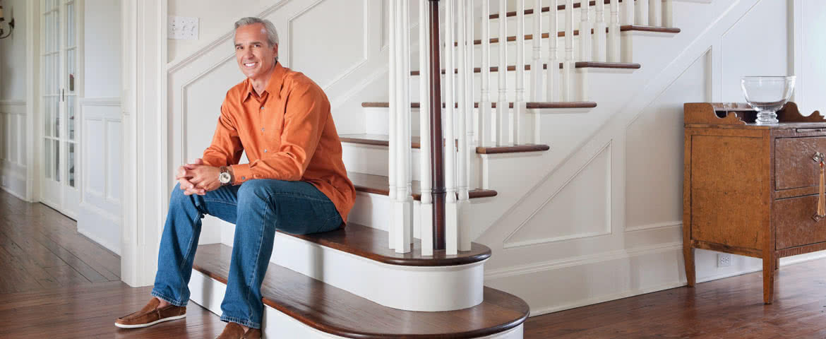Homeowner sitting on his staircase